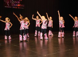 Young dancers pointing to the sky